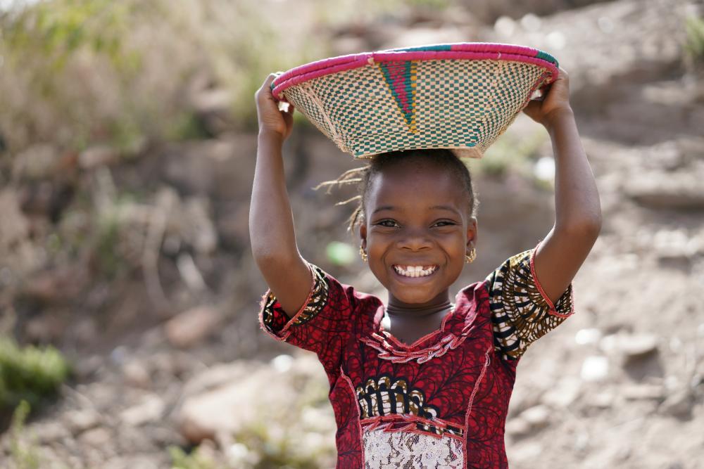 Girl carrying a basket and smiling 